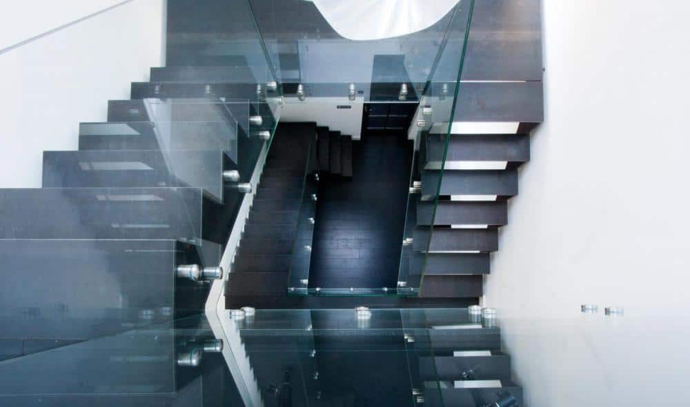 Overhead view of stairwell with glass railing