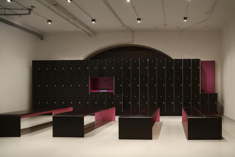 Locker room with black lockers and pink accent details