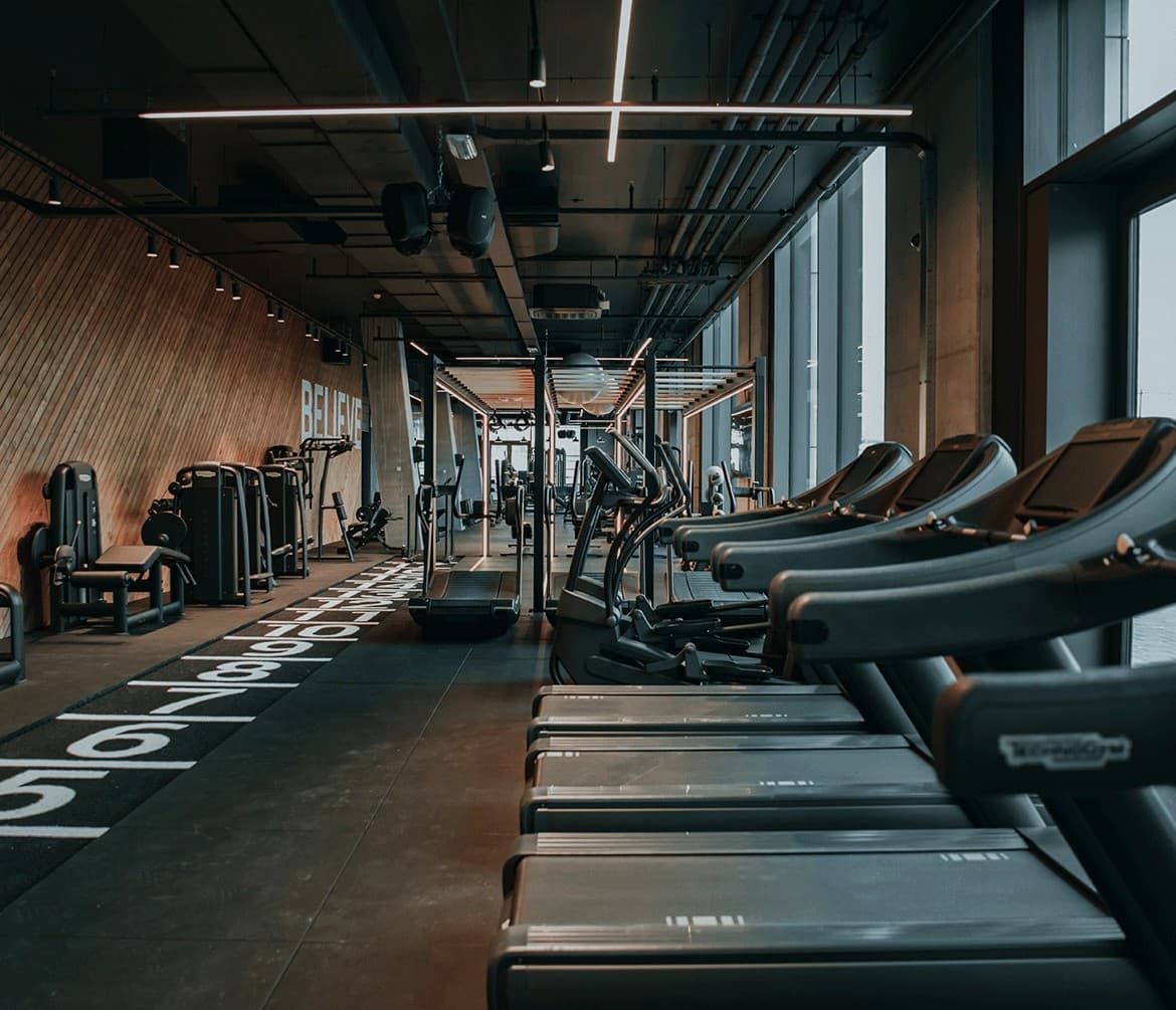 Treadmill row with timber wall and BELIEVE graphic