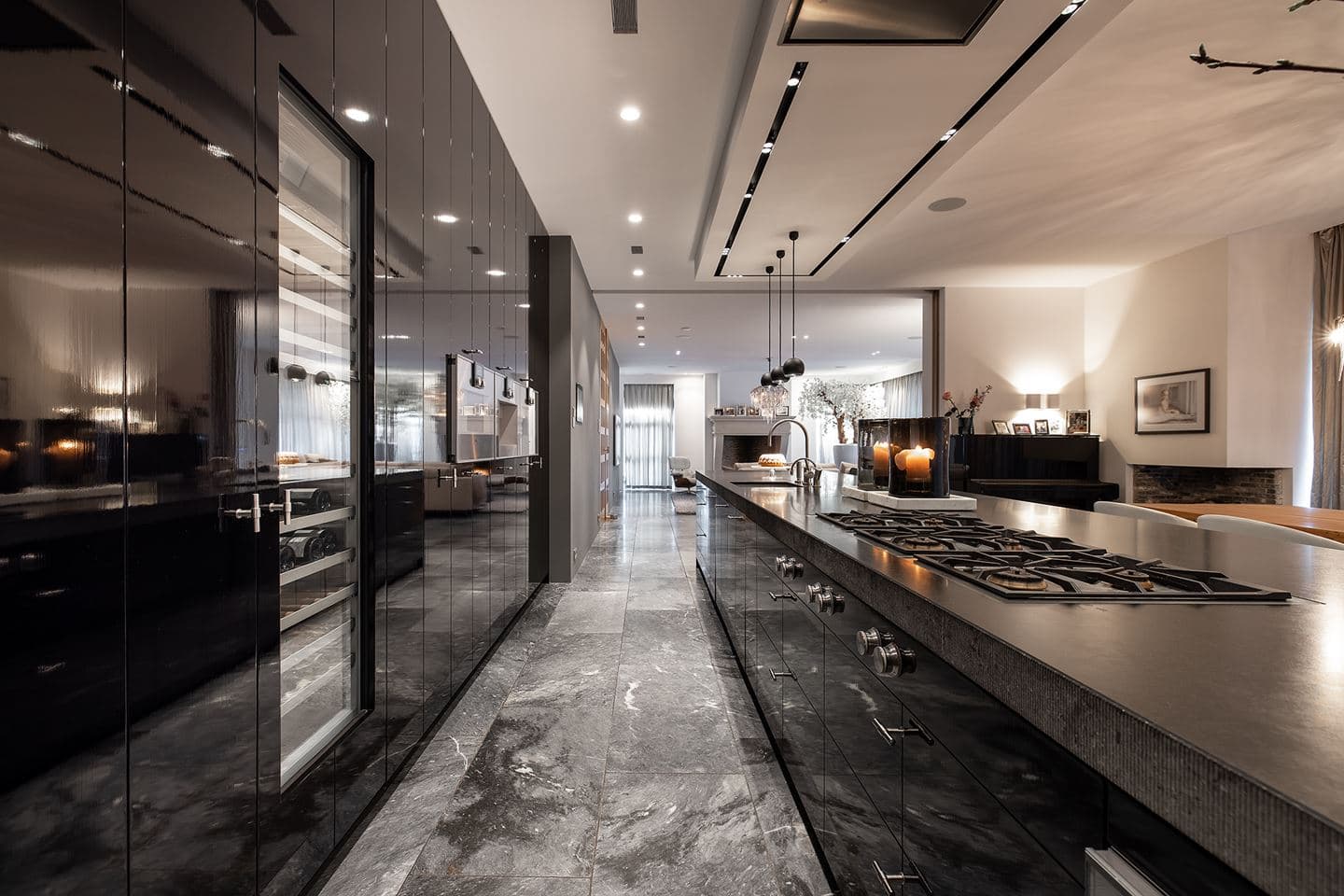 Villa Warmond — dark kitchen with glossy cabinets and marble floors